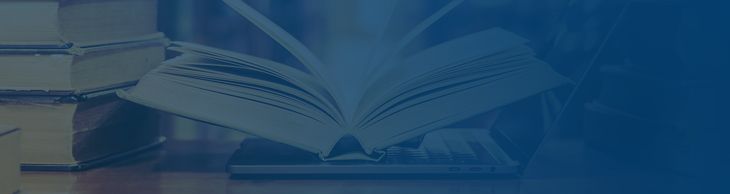 books on a table in a library under a blue silhouette