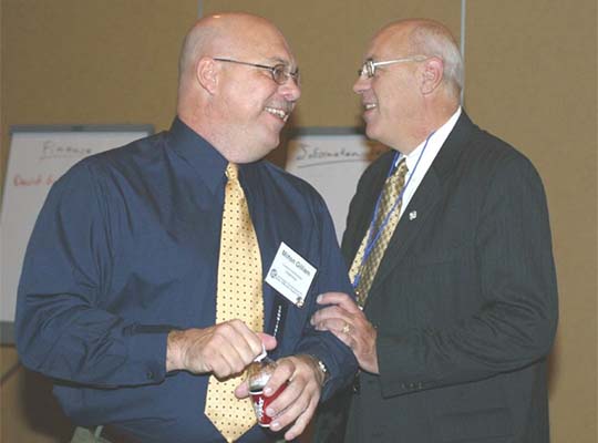 Vice-Chair Harry Hageman (OH) and Commissioner Milt Gilliam (OK) share a laugh. (2003)