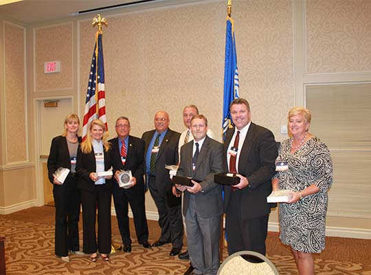 Executive Committee members are honored at the 2012 Annual Business Meeting in Madison, WI. Dori Littler (AZ), Kathie Winckler (TX), Gary Tullock (TN), Milt Gilliam (OK), Mike McAlister (NH), Charles Lauterbach (IA), Kevin Kempf (ID), Kim Madris (NV)