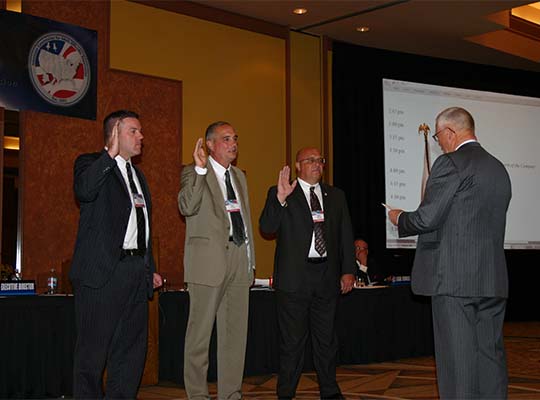 Senator Denton Darrington swears in new officers Chair Ken Merz (MN), Vice-Chair Milt Gilliam (OK), and  Treasurer Kevin Kempf (ID) at the 2008 Annual Business Meeting in Palm Springs, CA.