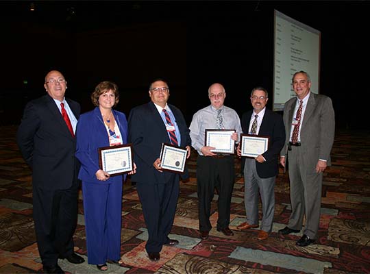 The outgoing region chairs are honored at the 2009 Annual Business Meeting in Reno, NV. Harry Hageman (Executive Director), Linda Janes (OH), Ed Gonzales (NM), Wayne Theriault (ME), Gary Tullock (TN), and Ken Merz (Chair)