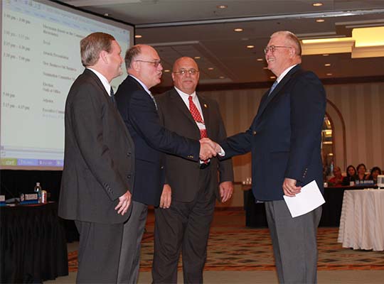 Senator Denton Darrington swears in new officers Chair Milt Gilliam (OK), Vice-Chair Wayne Theriault (ME), and Treasurer Charles Lauterbach (IA) at the 2010 Annual Business Meeting in San Antonio, TX.