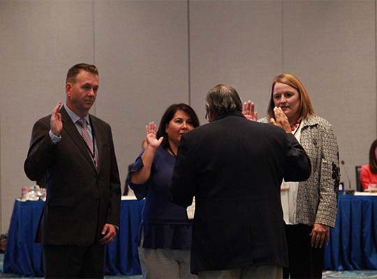 Chief Justice Barajas swears in Chair Jeremiah Stromberg (OR), Vice-Chair Hope Cooper (KS), and Region Chair Roberta Cohen (NM) at the 2018 Annual Business Meeting in Orlando, FL.