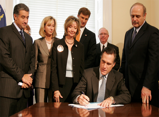 Pat Tuthill (Victim Advocate) and Don Blackburn (Executive Director) watch Mitt Romney, Massachusetts Governor, sign legislation to enact the Compact in 2005.