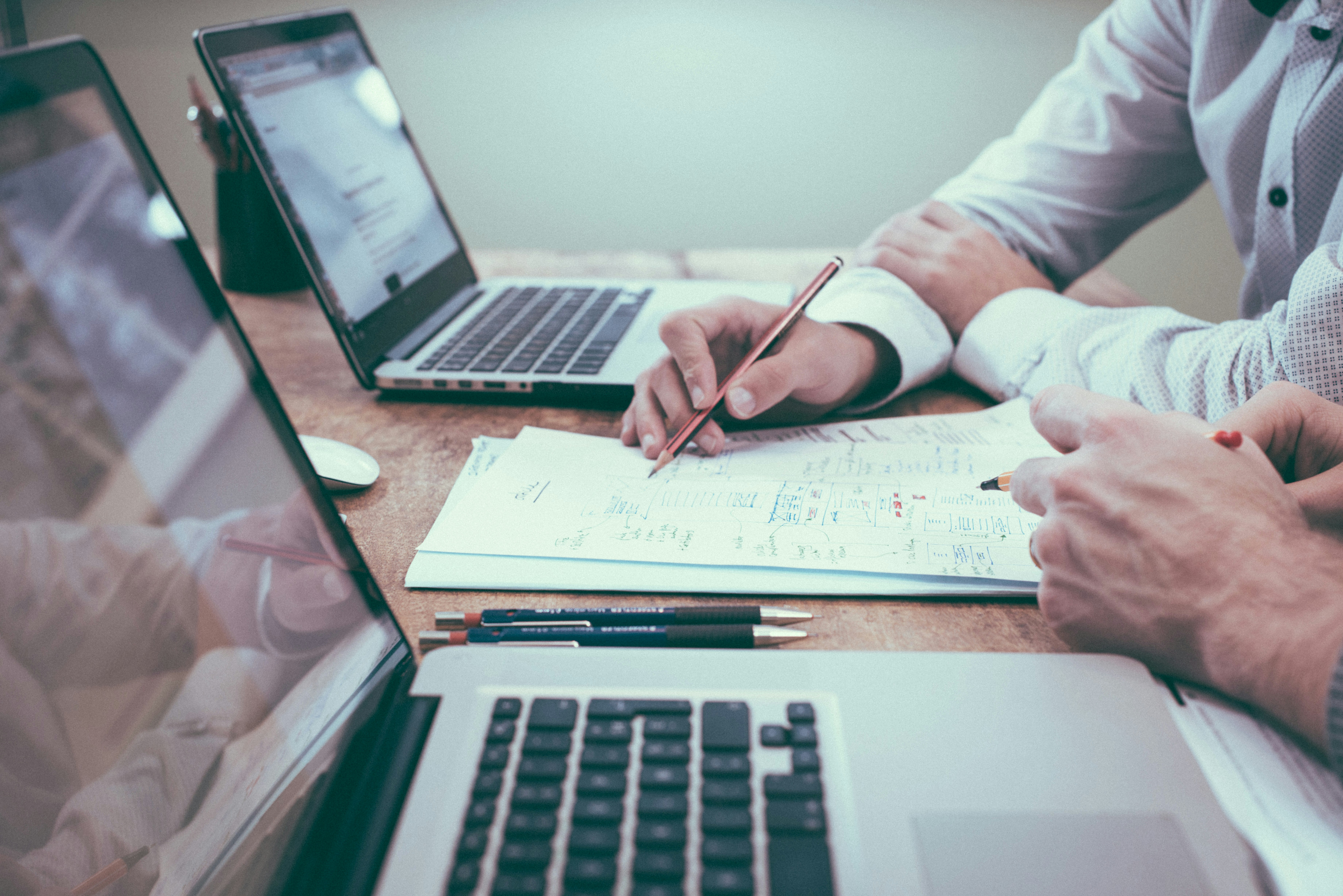 Two people at a desk looking at document