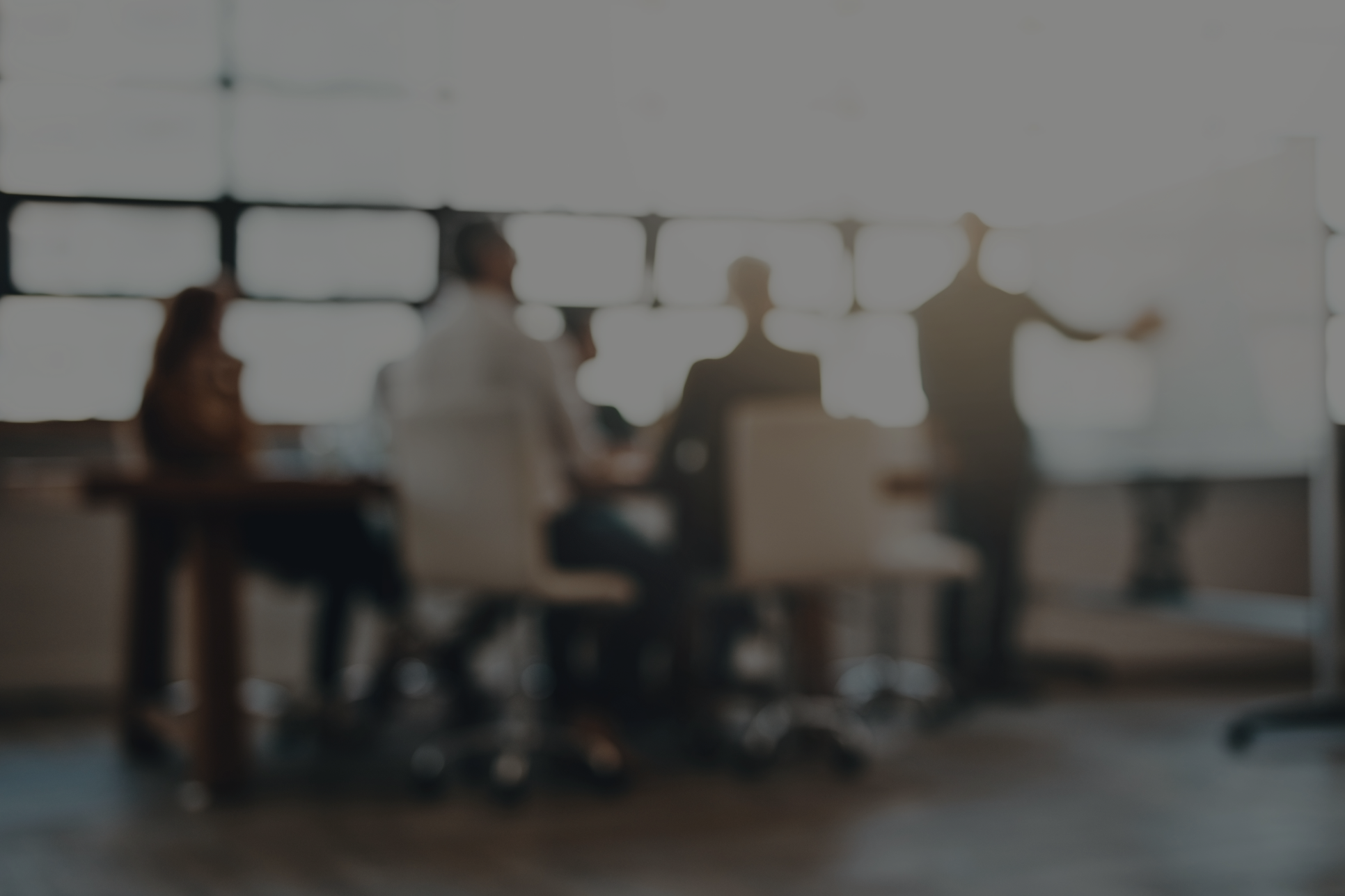 Group of people blurred sitting at a conference table